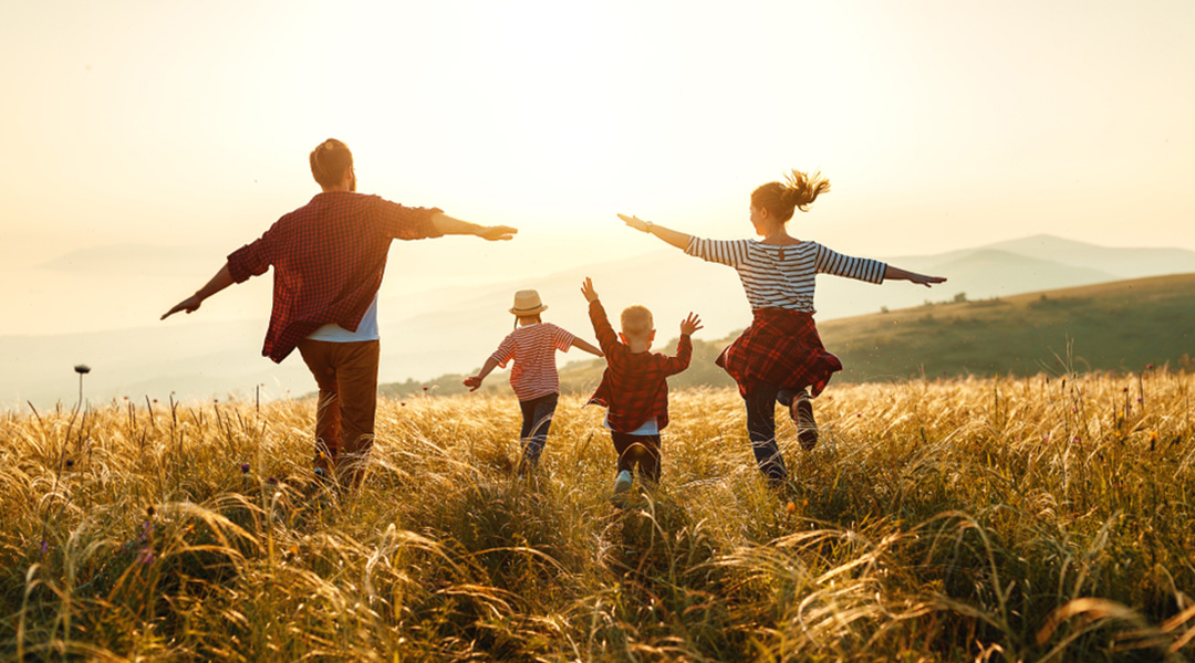 a family playing on a hill