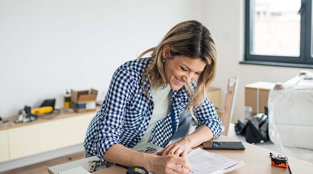 woman smiling looking down at paperwork