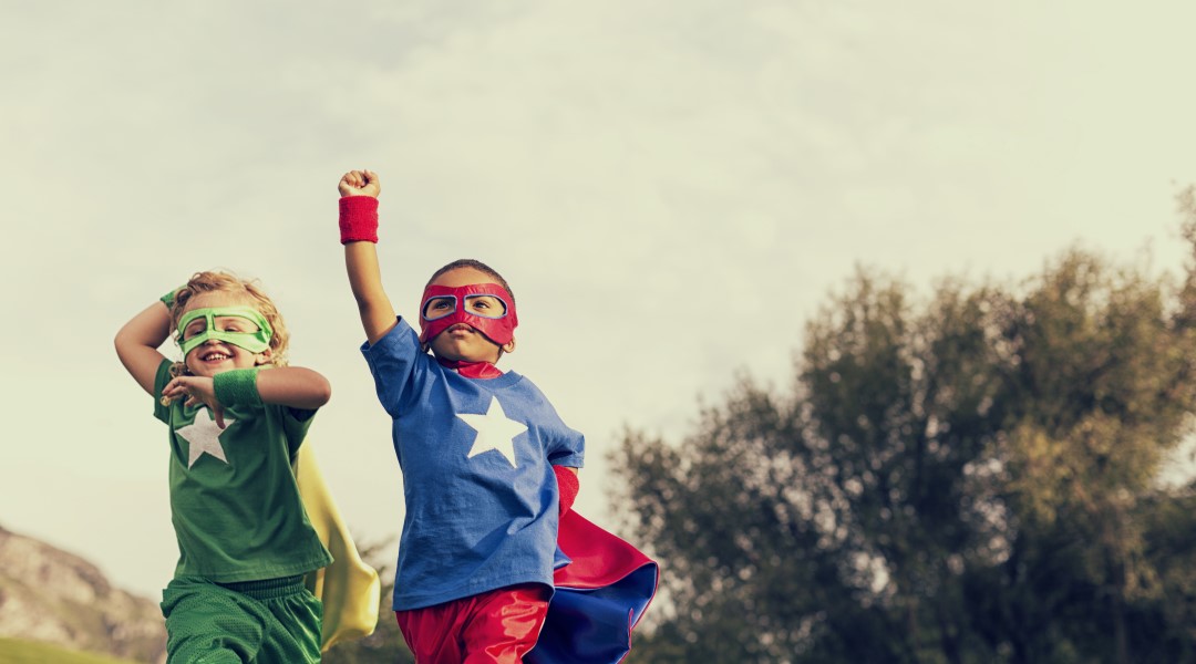 Cute kids in superhero costumes